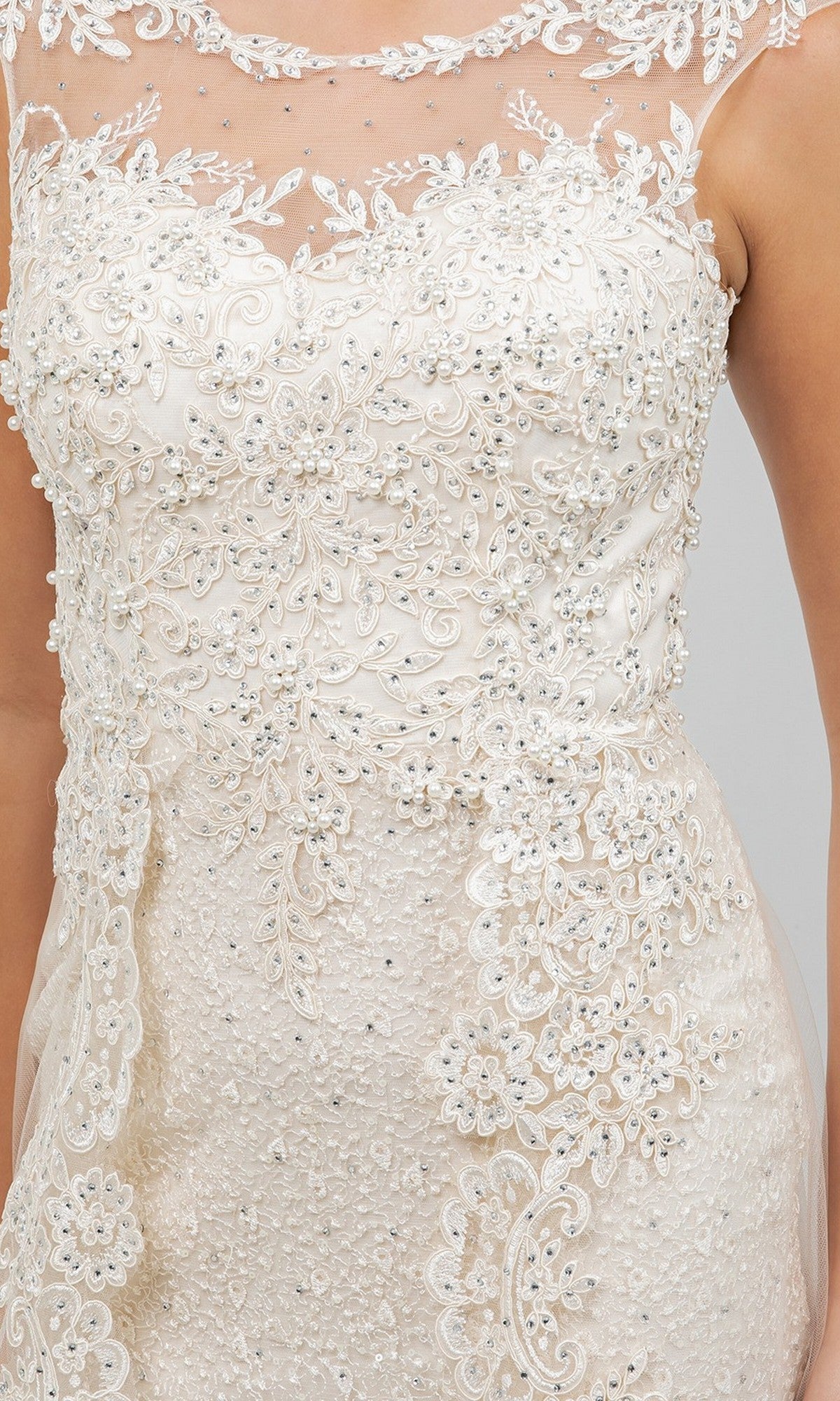 Close-up of the Cinderella Couture 8506J long formal dress, featuring intricate floral embroidery, shimmering beadwork, and sheer tulle fabric at the neckline, all adorned with delicate lace appliqués.